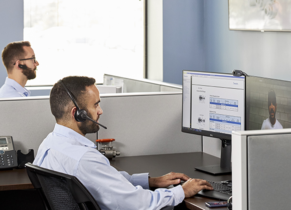 Male associates working in customer service at their desk