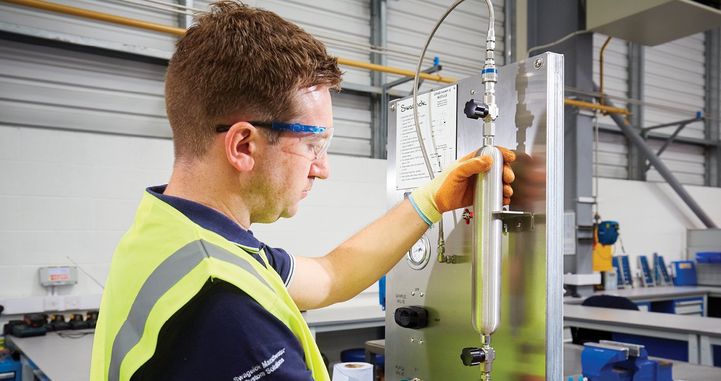 Custom solutions engineer attaching cylinder to panel