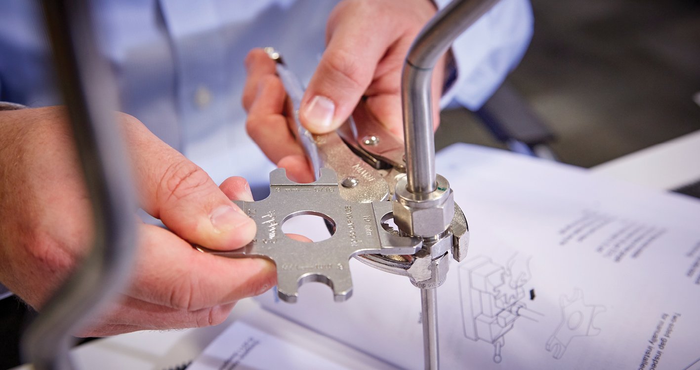 Closeup of associate that is tightening a gap gauge