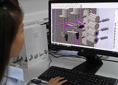 Associate looking at CAD design of a custom solution on computer