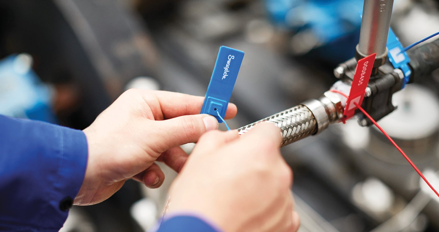 Field engineer adding a Swagelok tag to tube onsite